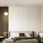 Bedroom with pendant lighting and vertical LED strips. The light provides a warm, ambient glow.