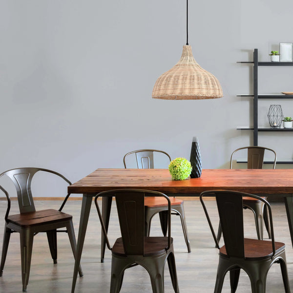 A woven pendant light hangs above a wooden dining table with rustic metal chairs. Natural light illuminates the room, casting a soft glow.