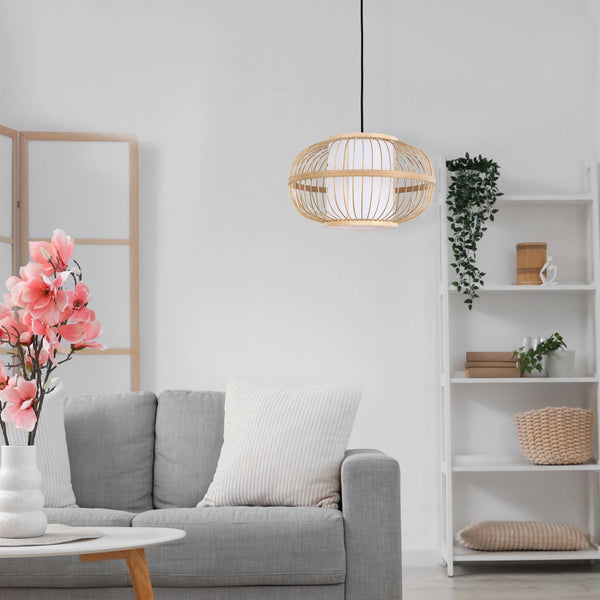 A bamboo pendant light hangs in a bright living room with white walls and neutral furnishings.
