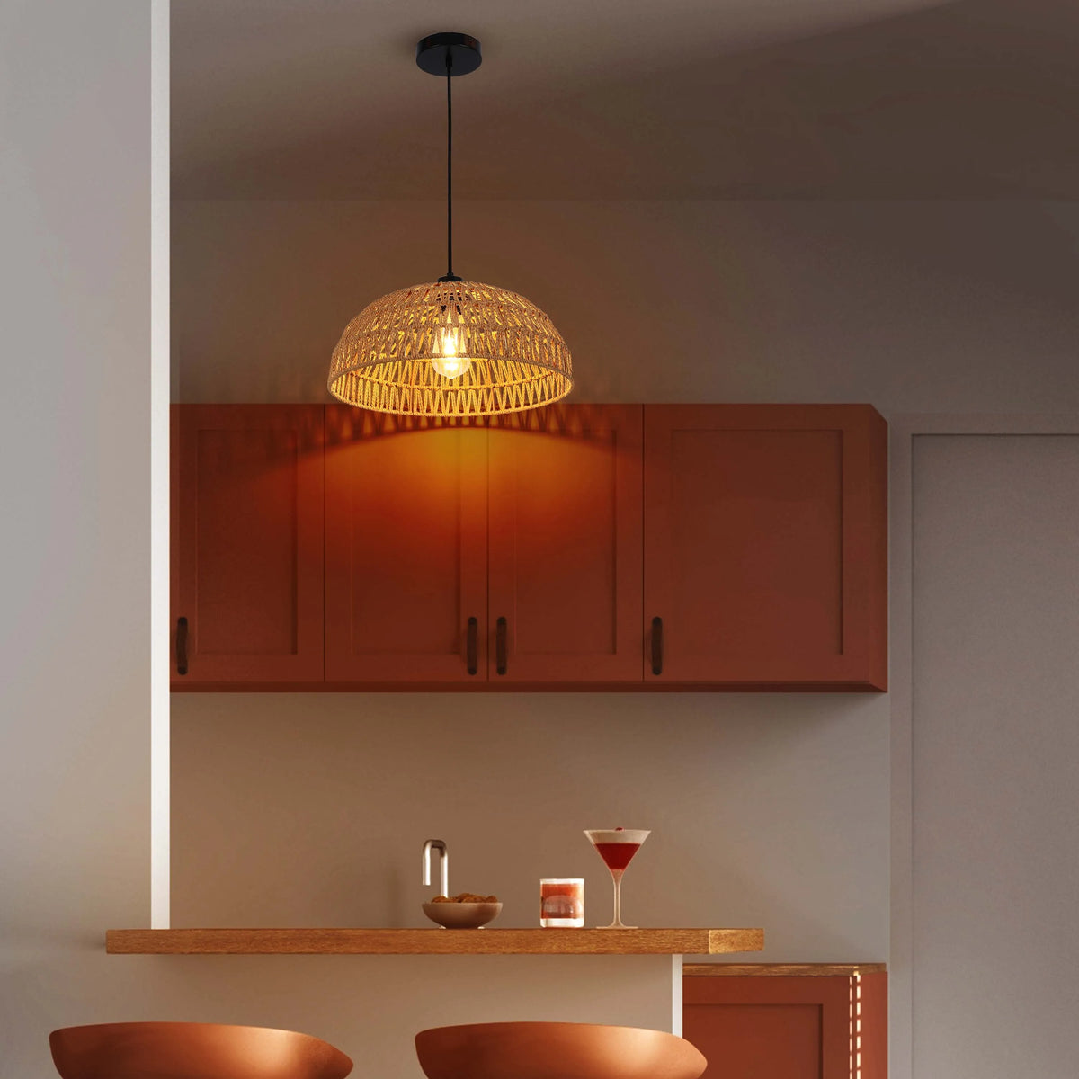 A warm, inviting kitchen featuring a woven pendant light, casting a cosy glow over the stylish bar area.