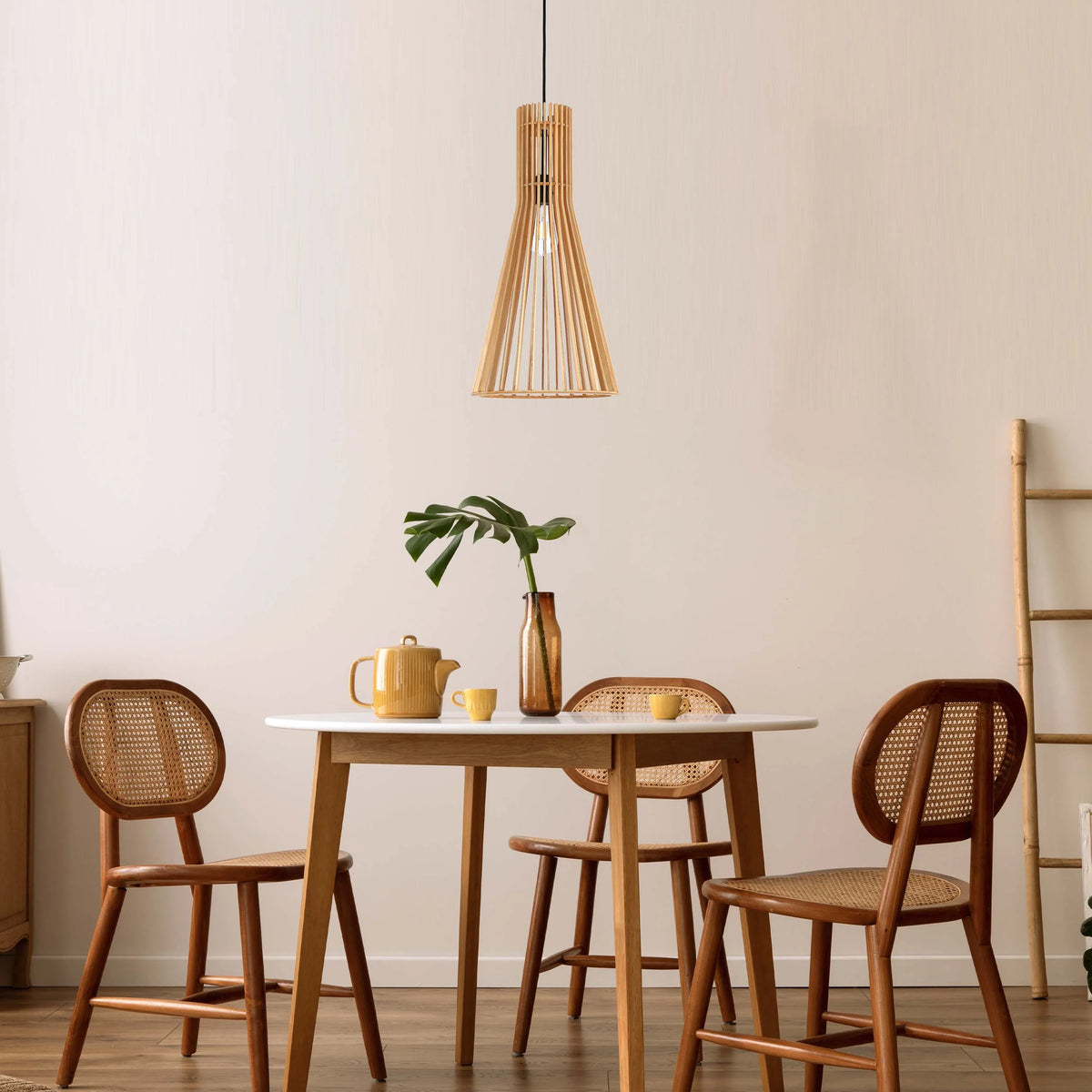 A sleek, modern wooden pendant light with an exposed bulb hangs above a stylish dining set in this bright, minimalist interior.