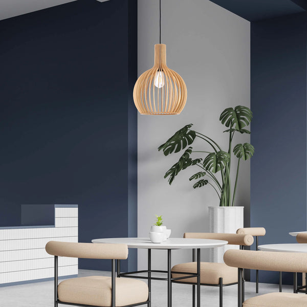 A stylish, wooden pendant light hanging above round tables and chairs in a modern cafe. The light's warm glow complements the neutral decor.