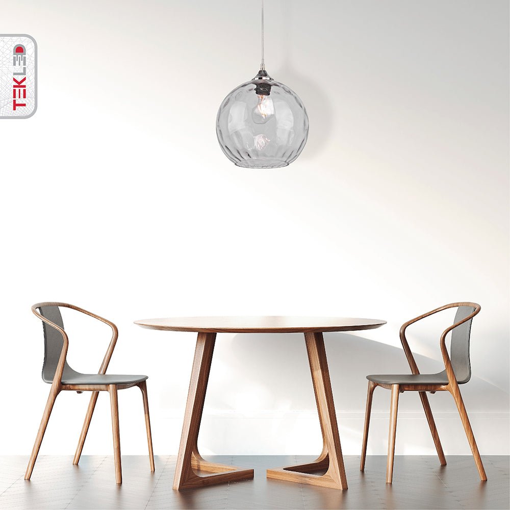 Clear glass globe pendant light with e27 fitting in indoor setting cafe table top