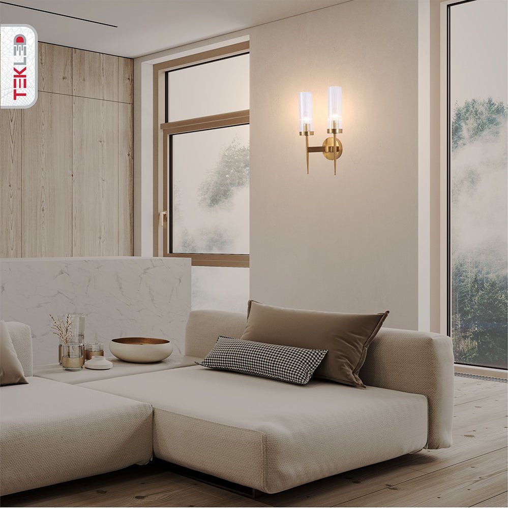 Gold Aluminium Bronze Cylinder Clear Glass Wall Light with 2xE14 Fitting in indoor setting living room