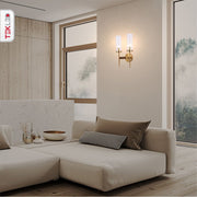 Gold Aluminium Bronze Cylinder Clear Glass Wall Light with 2xE14 Fitting in indoor setting living room
