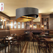 Grey fabric cylinder pendant light with e27 fitting in indoor setting cafe