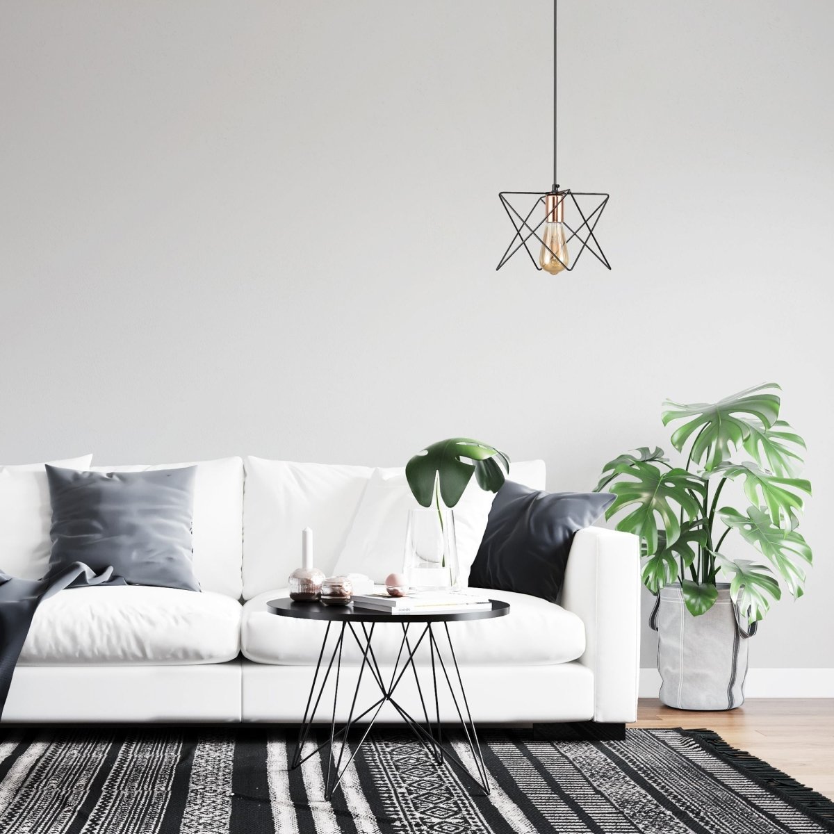 Black metal caged pendant light with e27 fitting in indoor setting living room use